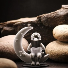 Street27 Astronaut Figurine Showpiece for Home Dcor Idols for Office Desk Table Astronaut Toy for Car Dashboard, Statue for Gift Gifting Items Birthday Decoration (Reading on Moon - Silver)